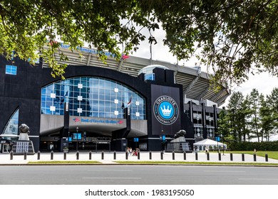 CHARLOTTE, NC, USA-30 MAY 2021: Sign and logo at main entrance to the Carolina Panthers Bank of America Stadium. Logo of the Charlotte Football Club. People. Entrance framed by spring foliage.