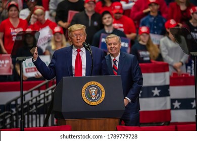 Charlotte, North Carolina - 2 March 2020: Senator Lindsey Graham Smiles Behind President Trump At The Rally In The Bojangle's Coliseum