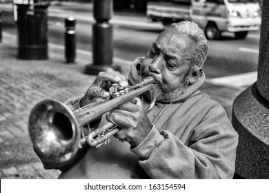 CHARLOTTE, NORTH CAROLINA OCTOBER 10: An unidentified African American street performer playing blues style music on the trumpet in uptown Charlotte on October 10, 2013.