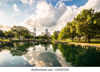 Charlotte, North Carolina skyline with the reflection of the clouds and buildings in the water. Taken from Marshall park. 