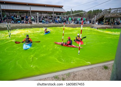 Charlotte, North Carolina/USA - March 16, 2019: The Annual Green River Revival Festival At The U.S. National Whitewater Center Where Every Year They Dye The Water Green To Celebrate St. Patrick's Day.