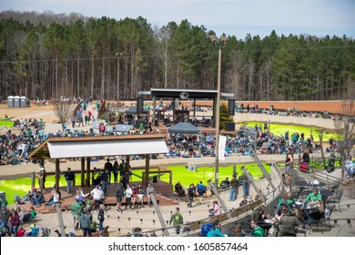 Charlotte, North Carolina/USA - March 16, 2019: The Annual Green River Revival Festival At The U.S. National Whitewater Center Where Every Year They Dye The Water Green To Celebrate St. Patrick's Day.