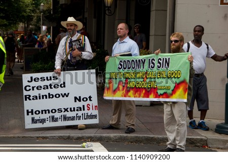 Charlotte/North Carolina, USA - August 17 2014:Charlotte Pride Parade with anti demonstration of people on the side, who are against gay people and are demonstrating a different belief in human rights