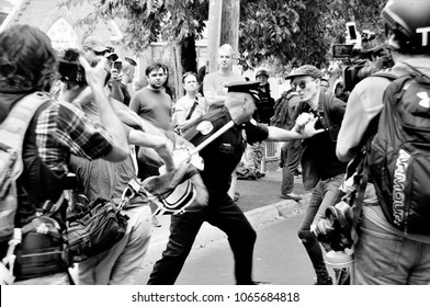 A Charlottesville City Police Officer Steps Between Protesters During The Rally On August 12, 2017 In Charlottesville, Virginia.