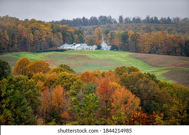 Charlottesville, USA - October 25, 2020: Trump Winery Vineyard Albemarle Estate white building architecture on grounds with American flag in Virginia in autumn fall foliage season