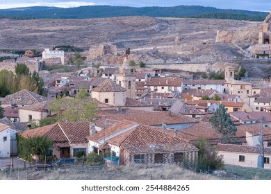 Charming Aerial View of a Spanish Village with Red Tile Roofs and Stone Buildings - Powered by Shutterstock