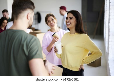 Charming attractive female hipsters talking with male coworker joking and having fun while making preparation for designing office indoor collaborating and helping each other in friendly atmosphere - Powered by Shutterstock