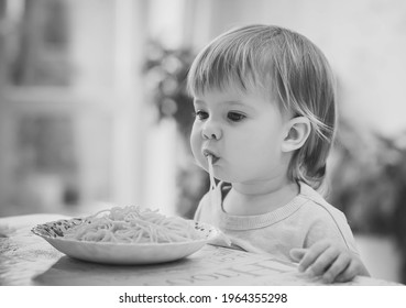 Charming Baby Girl Eating Spaghetti By Hands