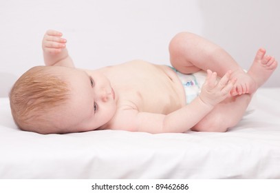 Charming Baby. Baby Girl Lying On Back