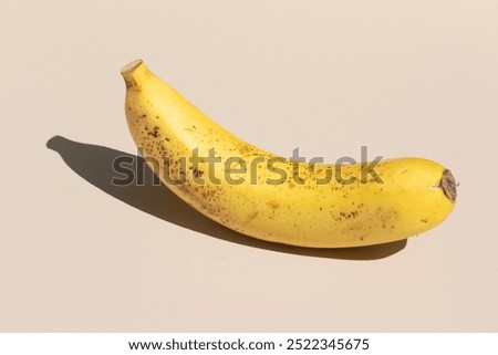 Charming Banana Lying Flat on Cream Clean Surface: Best for Nutritional Articles and Recipe Visuals