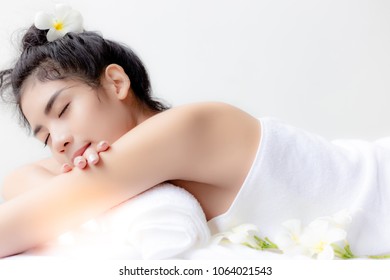 Charming beautiful asian woman is lying on bed at spa shop. Gorgeous asia girl is a customer and waiting for massager. Attractive young woman feels relaxed and happy. She has good health. copy space
