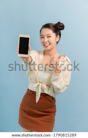 Charming beautiful attractive lady taking photo offering suggesting advising product raising her thumb up over vivid background