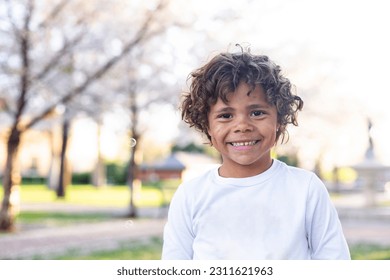 Charming Beautiful Black young boy with a playful smile and curly hair. Outdoor candid portrait of a natural beauty - Shutterstock ID 2311621963
