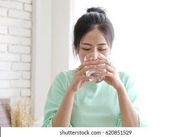 Charming Beautiful Tan Skin Asian Business Chic Woman Drink Clean Water Glass. Presenting Your Product With Good Looking Woman Face.