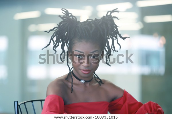 Charming Black Female Dreadlocks Buns Sitting Stock Photo