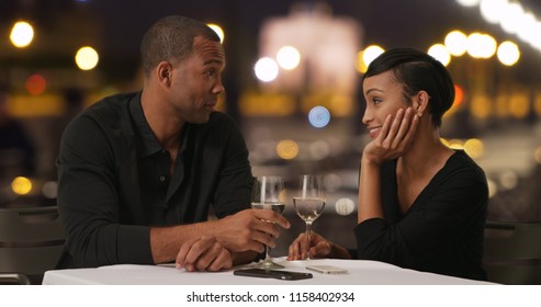 Charming Black Male And His Date Drinking Wine At Nice Fancy Restaurant In Europe