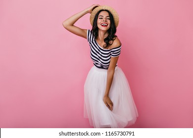 Charming Black-haired Girl In Romantic Outfit Posing On Pink Background. Studio Shot Of Wonderful Lady In Lush Skirt Enjoying Photoshoot.