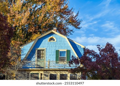 Charming blue house surrounded by autumn foliage in Watertown, Massachusetts, USA - Powered by Shutterstock