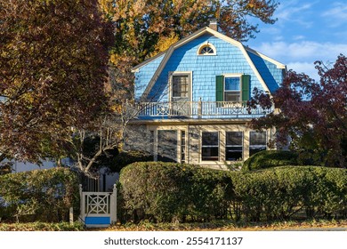 Charming blue house surrounded by autumn foliage in Watertown, Massachusetts, USA - Powered by Shutterstock