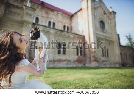 charming bridal playing with her dog outside