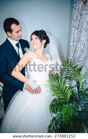 Charming bride and groom on their wedding celebration in a luxurious restaurant. Wedding bouquet of flowers and bridal dress. newly married couple in luxury modern hotel hall