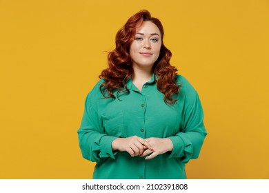 Charming bright happy young ginger chubby overweight woman 20s years old wears green shirt looking camera smiling isolated on plain yellow background studio portrait. People emotions lifestyle concept