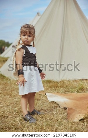 Charming child child in primitive clothes at the viking festival 