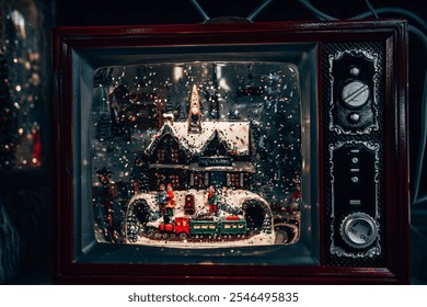 A charming Christmas scene inside a vintage TV-inspired snow globe. The snowy miniature train station with holiday figures captures the nostalgic warmth and magic of the holiday season - Powered by Shutterstock