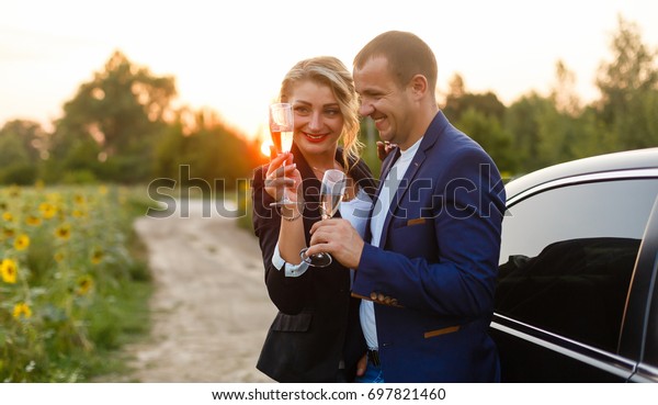 The\
charming couple in love with glass of\
champagne