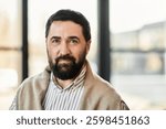 A charming elderly man dressed casually engages warmly with friends in a bright, inviting space.