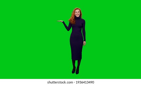 Charming elegant red headed business woman in long dress doing presentation and gesturing on green screen background - Powered by Shutterstock