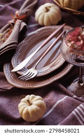 A charming fall-inspired dining setup featuring white pumpkins, textured linen, dried florals, and a vintage glass, ideal for Thanksgiving gatherings and holiday invitations