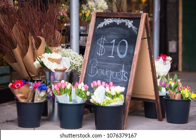 Charming florist sidewalk display of flowers and sign - Powered by Shutterstock