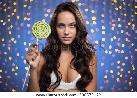 Charming girl with long hair holding lollipop