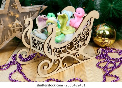 Charming Handmade Snowman and Snake Soap Figures in Rustic Wooden Sled: A Whimsical Winter Scene That Captures Joy of the Season, Perfect for Holiday Decor and Unique Gifting Ideas. - Powered by Shutterstock