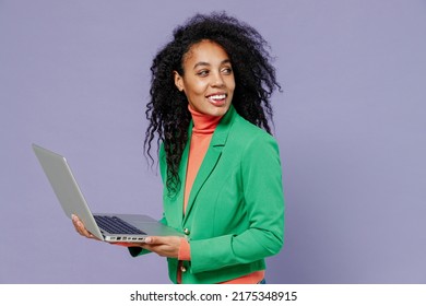 Charming Happy Charismatic Vivid Young Black Curly Woman 20s Wears Green Shirt Hold Use Work On Laptop Pc Computer Looking Back Behind Isolated On Plain Pastel Light Violet Background Studio Portrait