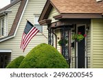 Charming Home Exterior with US Flag, Decorative Ironwork and Hanging Flower Baskets, Brighton, Massachusetts, USA