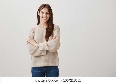 Charming Housewife Started Her Own Business. Portrait Of Attractive Caucasian Adult Woman In Casual Outfit Standing Confident Over Gray Background With Crossed Hands And Smiling Cheerfully