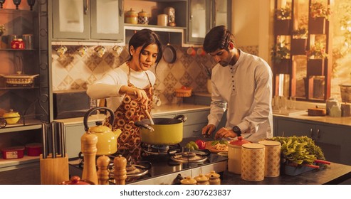 Charming Indian Couple Preparing Food Together: Laughing and Sharing Stories, Creating Delicious Meals, Strengthening Their Bond in a Cozy Kitchen. - Powered by Shutterstock