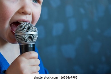 Charming Kid Sings Into Microphone And Opens Her Mouth Wide With Milk Teeth Dropped Out.