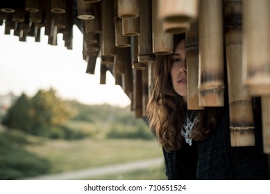 charming lady in black between decorations of bamboo