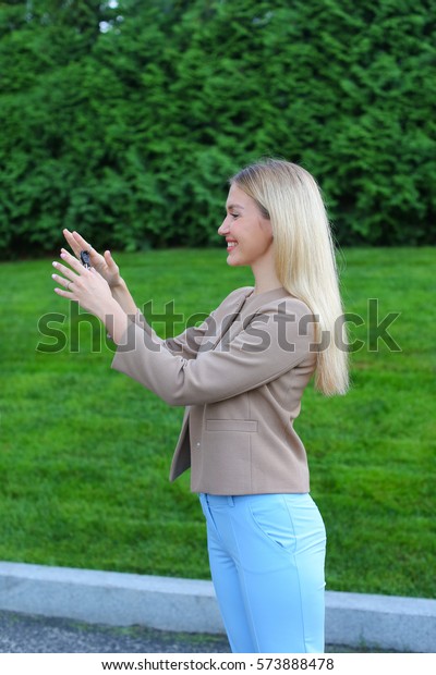 Charming Lady European appearance rejoices\
acquisition machine or your own apartment, overflowing emotions\
girl smiling broadly and showing keys. Women with long blonde hair\
dressed in bright\
blouse