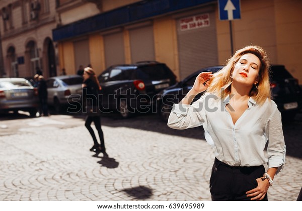 The charming lady\
standing on the street