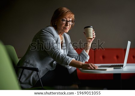 Similar – Young woman looking at cellphone