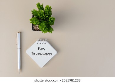 A charming note of Key Takeaways accompanied by a pen on a desk, creating a warm and inviting setup for creative projects.