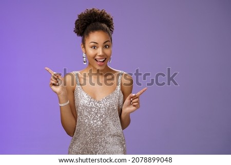 Charming outgoing african-american party girl have fun dancing pointing different sides right left show choices variants smiling broadly asking advice which way go, standing blue background