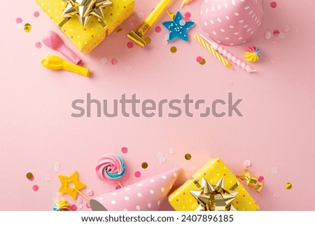 Charming party essentials layout. Top view of jubilant table arrangement with celebratory elements such as gift packages, party hats, lollipops, candles, balloons, confetti on pastel pink surface