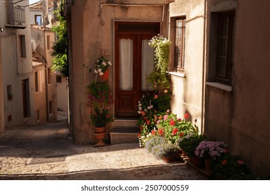 In a charming and picturesque alley, there is a beautiful doorway adorned with an abundance of vibrant flowers - Powered by Shutterstock