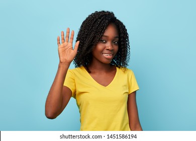 charming positive woman showing her palm. close up photo. isolated blue background.hi. hellow, gesture and body language