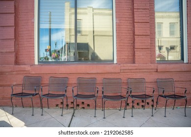 In A Charming Small Town, Inman, S.C., Cute Iron Chairs Sitting Out On The Sidewalk In Front Of A Restaurant With Brick Exterior, On Famous Mill Street.